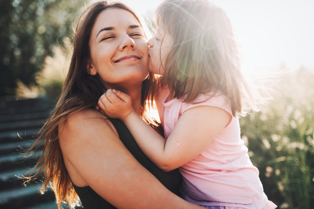 Girl Kissing Her Mother Photo of a Girl Kissing Her Mother