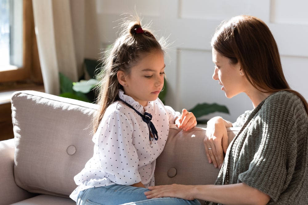 Woman Talking To A Child On A Couch