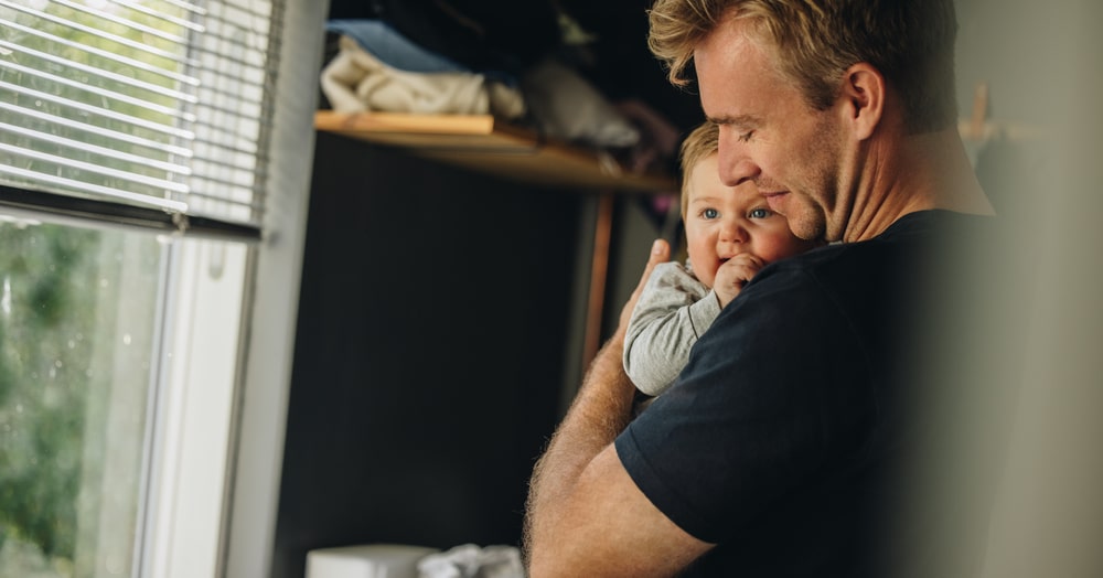 Father Holding His Child In His Arms