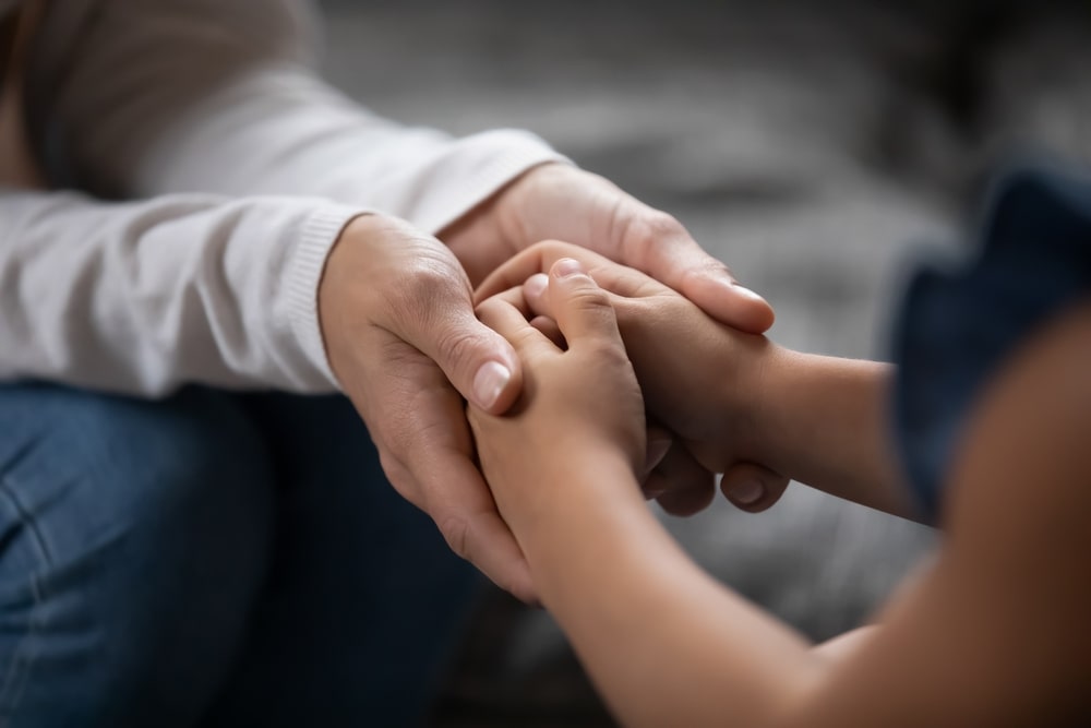 Adult Hands Holding Childs Hands