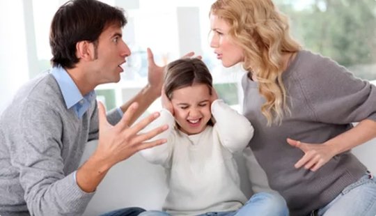 Couple arguing in front of the child