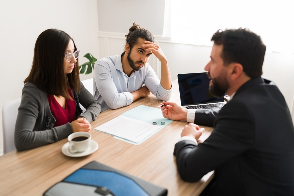 A Divorcing Couple Talking With A Divorce Attorney