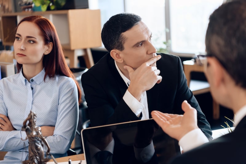 Meeting With Divorce Attorney Woman And A Man Listening To Their Attorney Talking