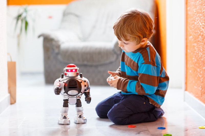 A Child Playing With His Toy Robot