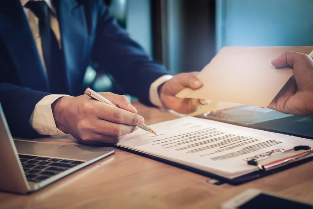 Lawyer receiving envelop from client on account of legal fees