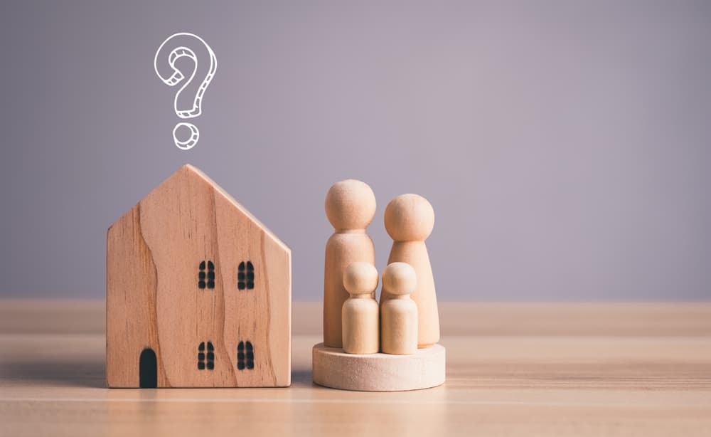 Model house and question mark on top. Home Division in Divorce.